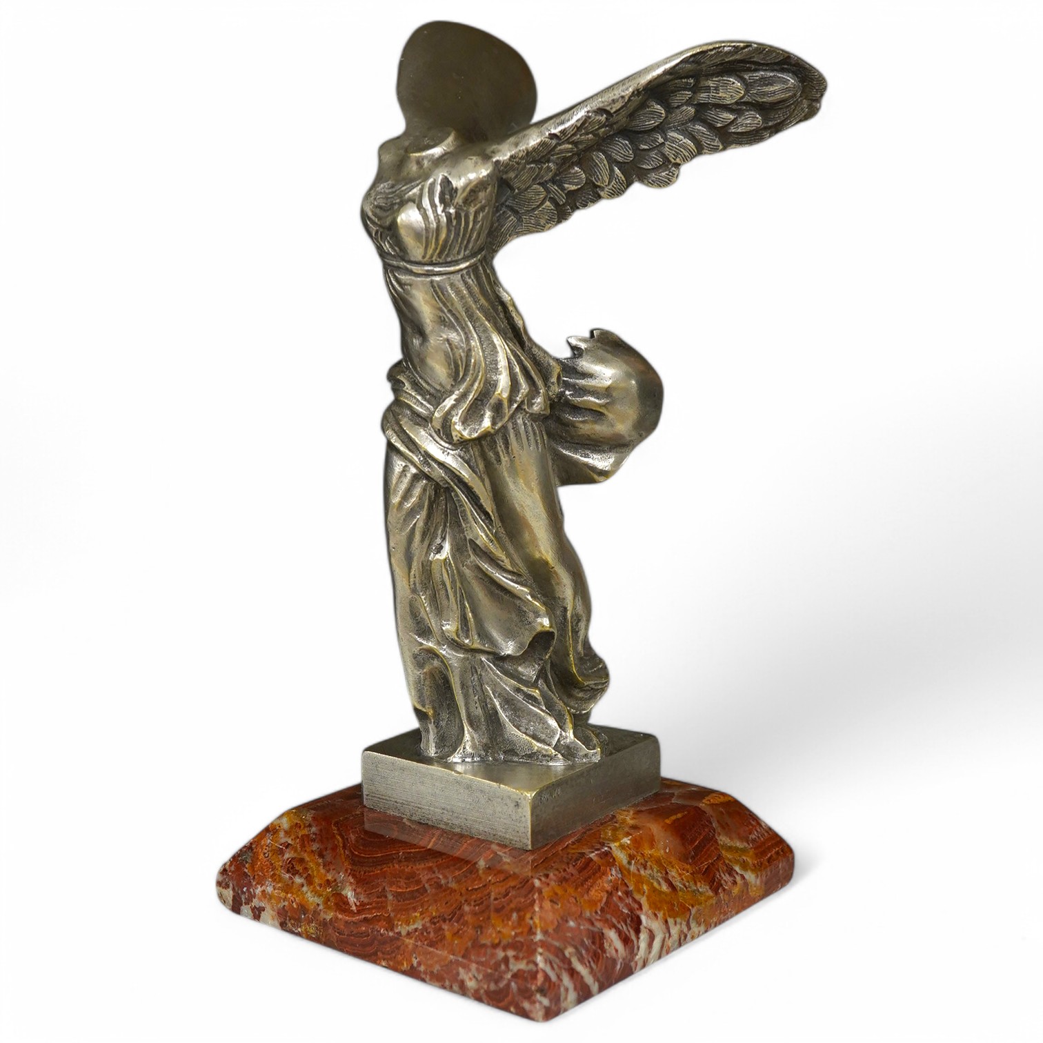 A winged Victory figure of Samothrace in silvered bronze, 22cm high. Condition - good